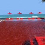 the-library-in-thailand-has-a-pool-boasting-a-unique-look-with-blood-red-tiles-creating-a-cool-effect-that-nicely-contrasts-the-beach